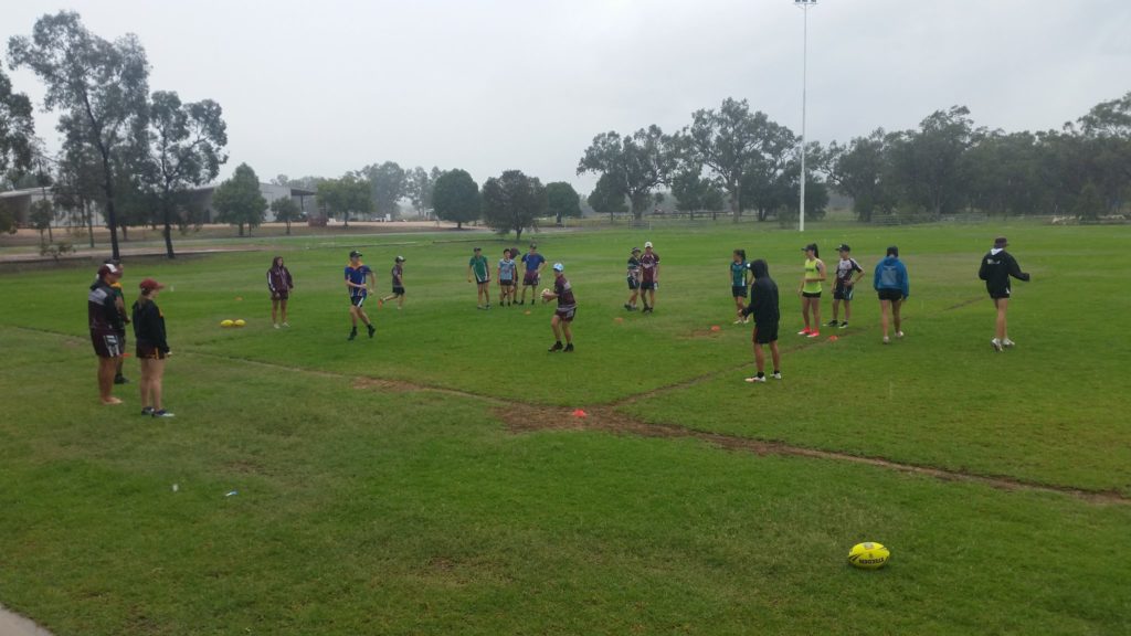 Kids playing touch football in the rain