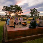 A group of people sitting around a firepit