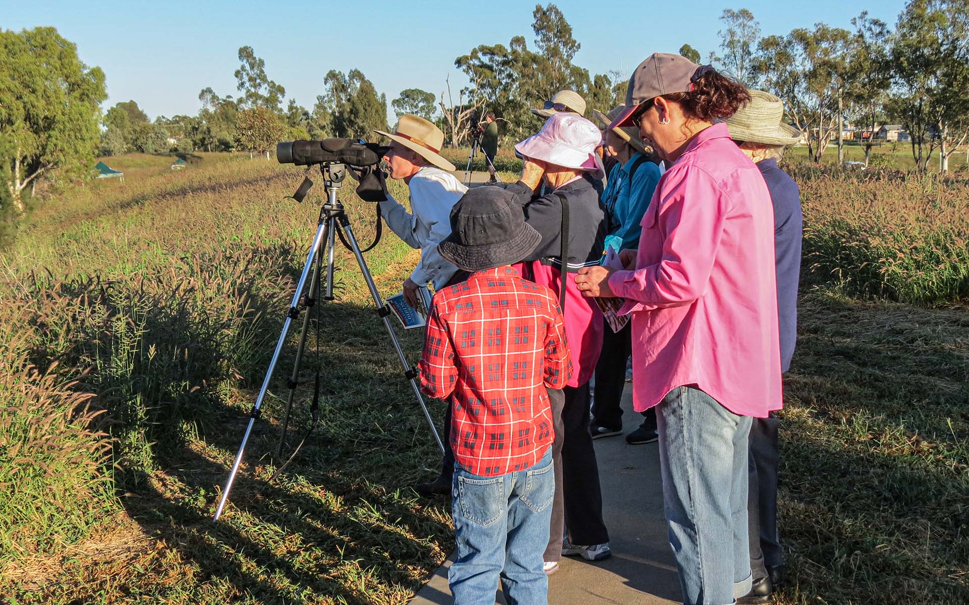 Group of people bird spotting at Roma Bush Gardens