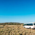 A bus driving through bushlands