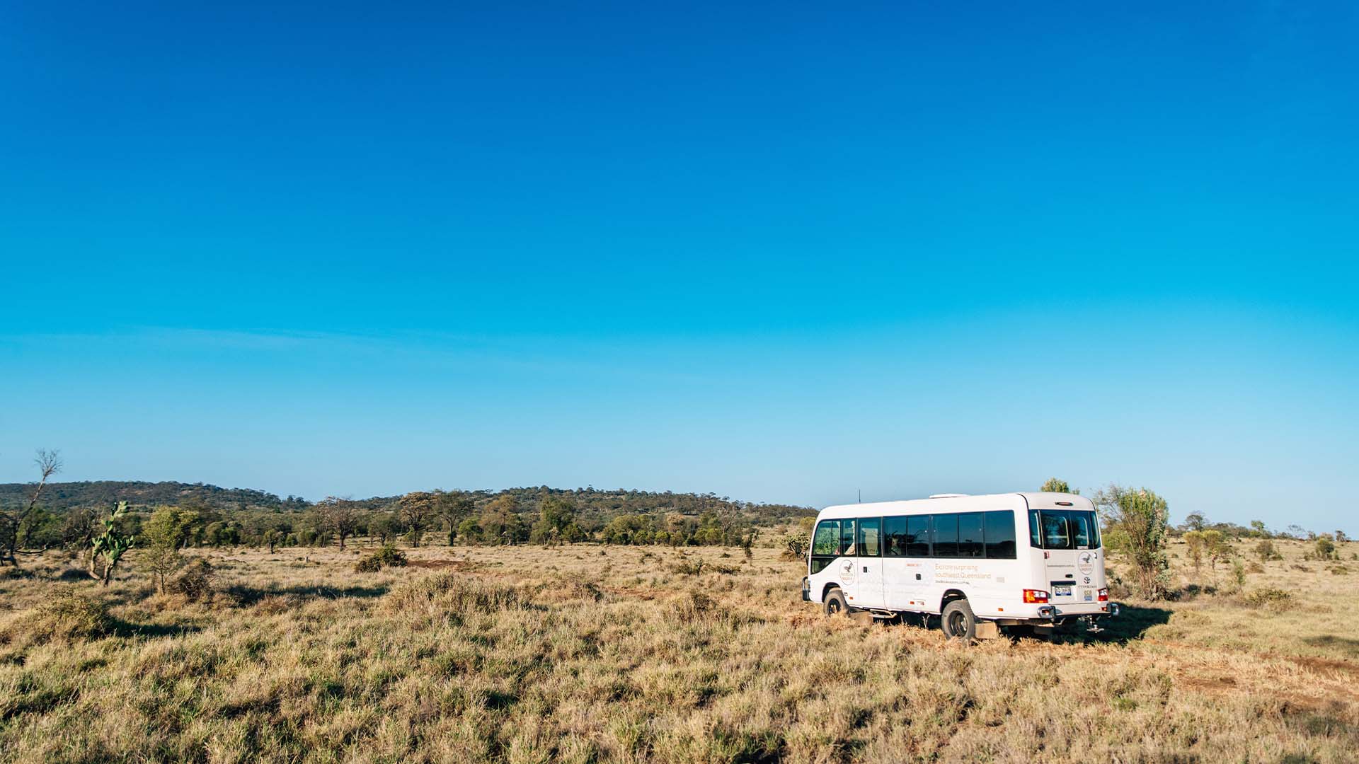A bus driving through bushlands