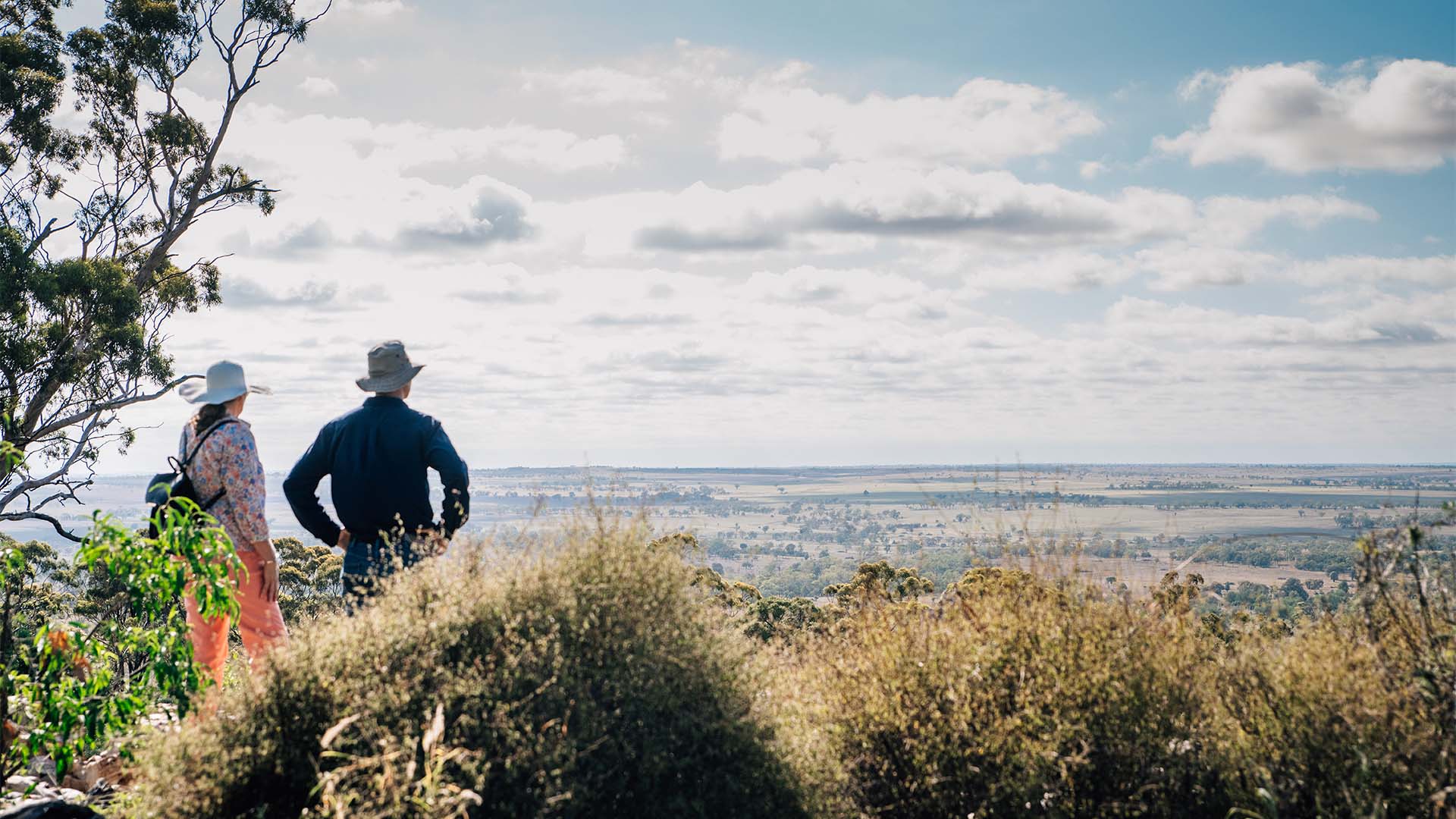 Two people looking out at a landscape below