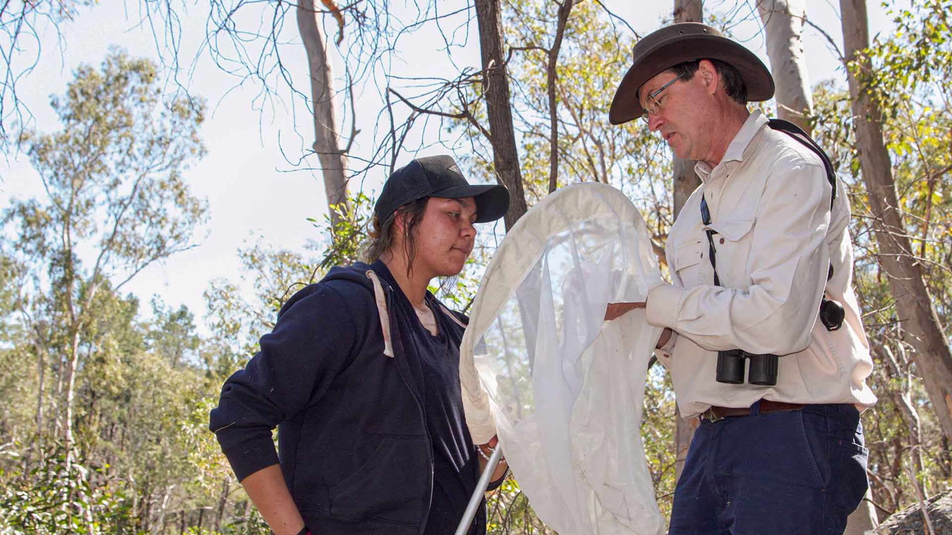 two people looking into a net