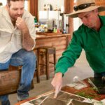 two people looking at a map, planning their journey