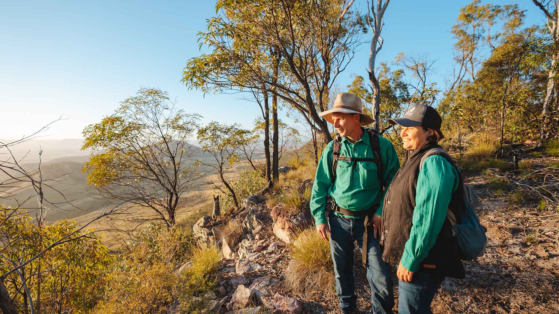 two tour guides looking out to the valley below