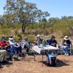 Boobook Explore guests seated and enjoying morning tea in a bush setting