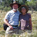 Elderly couple standing amongst a field of Australian Wildflowers