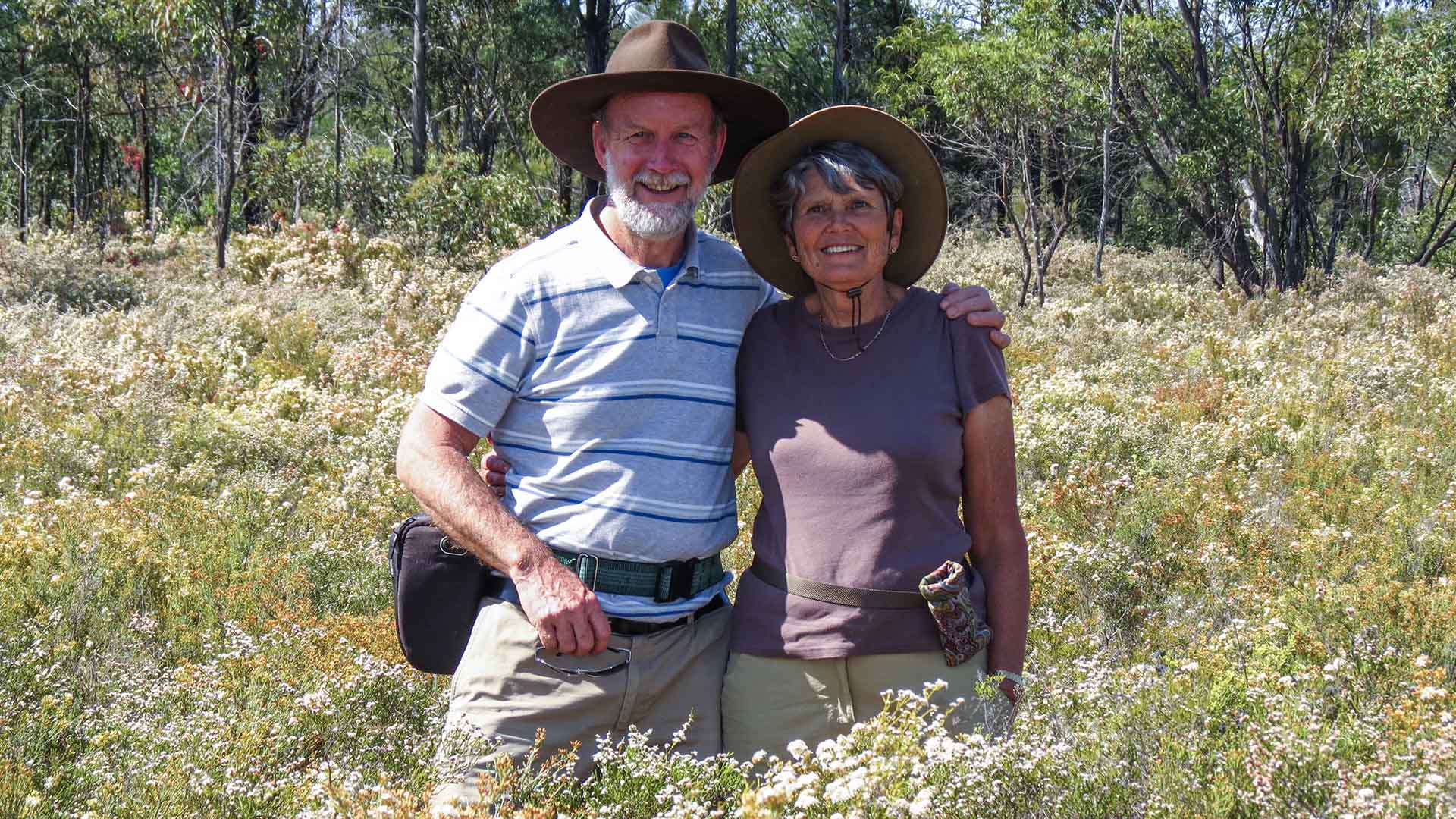 Elderly couple standing amongst a field of Australian Wildflowers