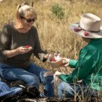 Two ladies enjoying morning tea in a bushland setting