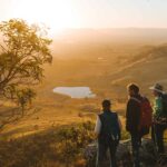 A group of guests looking out at Arcadia Valley as the sun sets